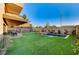 Expansive backyard with lush artificial turf, inviting pool and spa, and a cozy patio area at 1181 Calle De Luz, Henderson, NV 89012