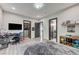 Spacious bedroom with hardwood floors, a closet, a TV, and neutral decor at 1181 Calle De Luz, Henderson, NV 89012