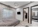 Well-lit bedroom with modern decor, leading to a walk-in closet and bathroom at 1181 Calle De Luz, Henderson, NV 89012