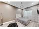 Cozy bedroom featuring a plush bed, stylish lighting, and elegant window coverings at 1181 Calle De Luz, Henderson, NV 89012