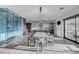 Open concept living area with modern dining set, sleek kitchen and stunning glass wine rack at 1181 Calle De Luz, Henderson, NV 89012