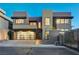 Modern home showcasing stylish garage, sleek architecture, and illuminated exterior at twilight at 1181 Calle De Luz, Henderson, NV 89012