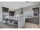 Modern kitchen with stainless steel appliances, a large island with seating, and elegant cabinetry at 1181 Calle De Luz, Henderson, NV 89012