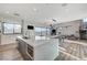 A modern kitchen and living area with large island, stainless steel appliances, and an open floor plan at 1181 Calle De Luz, Henderson, NV 89012
