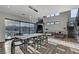 Bright, open-concept living room features modern furnishings, a decorative chandelier, and a large glass wall overlooking the backyard at 1181 Calle De Luz, Henderson, NV 89012