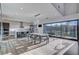 Bright, modern living area with dining space, kitchen, hardwood floors and sliding glass doors at 1181 Calle De Luz, Henderson, NV 89012