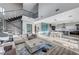 Open-concept with a large living room, dining area, and kitchen, featuring an open staircase and modern furnishings at 1181 Calle De Luz, Henderson, NV 89012