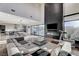 Open-concept living room and kitchen with a large sectional sofa, a fireplace, and outside access to the patio at 1181 Calle De Luz, Henderson, NV 89012