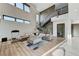 Spacious living room with high ceilings, large windows, and a modern staircase at 1181 Calle De Luz, Henderson, NV 89012