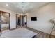 Spacious primary bedroom featuring a unique light fixture, hardwood floors, and ensuite at 1181 Calle De Luz, Henderson, NV 89012