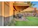 Inviting outdoor patio with stylish seating, a cozy swing, and a lush lawn, perfect for relaxation and entertainment at 1181 Calle De Luz, Henderson, NV 89012