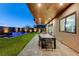 Cozy patio extends from the home to a well-lit backyard with a sparkling pool, perfect for evening relaxation at 1181 Calle De Luz, Henderson, NV 89012