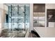 Modern kitchen with glass enclosed wine cellar and stainless steel refrigerator at 1181 Calle De Luz, Henderson, NV 89012