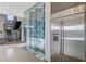 Contemporary wine cellar with a glass enclosure and a stainless steel refrigerator at 1181 Calle De Luz, Henderson, NV 89012