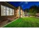 Backyard with a well manicured lawn, desert landscaping, and patio furniture at 12 Kennesaw Rd, Henderson, NV 89052