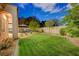 Large grass backyard with a dining set and patio area, perfect for outdoor entertaining at 12 Kennesaw Rd, Henderson, NV 89052