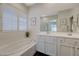 Bathroom features a soaking tub, glass-enclosed shower, and white vanity with double sinks at 12 Kennesaw Rd, Henderson, NV 89052