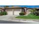 Attractive home with a two-car garage, manicured lawn, and well-maintained landscaping at 12 Kennesaw Rd, Henderson, NV 89052