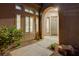 Inviting front entrance with desert landscaping and well-lit arched doorway at 12 Kennesaw Rd, Henderson, NV 89052