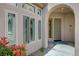 Inviting front entrance with arched porch, desert landscaping, and unique front door at 12 Kennesaw Rd, Henderson, NV 89052