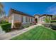 Charming single-story home with manicured front lawn, colorful shrubs, and stone walkway at 12 Kennesaw Rd, Henderson, NV 89052