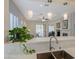 Open-concept kitchen with a breakfast bar overlooking the living and dining areas at 12 Kennesaw Rd, Henderson, NV 89052