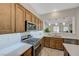 Well-lit kitchen features stainless steel appliances, light countertops, and wood cabinetry at 12 Kennesaw Rd, Henderson, NV 89052