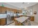 Modern kitchen featuring stainless steel appliances, quartz countertops, and a center island with bar seating at 12 Kennesaw Rd, Henderson, NV 89052