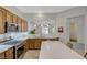 Updated kitchen featuring light countertops, stainless steel appliances, and wood cabinets at 12 Kennesaw Rd, Henderson, NV 89052