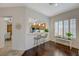 Cozy living area with hardwood floors, a breakfast bar, and plantation shutters at 12 Kennesaw Rd, Henderson, NV 89052