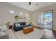 Comfortable living room with hardwood floors, plantation shutters, and sliding doors to the outdoor patio at 12 Kennesaw Rd, Henderson, NV 89052