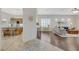 Open-concept living area with hardwood floors, leading into the kitchen with bar seating at 12 Kennesaw Rd, Henderson, NV 89052
