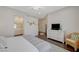 Bright main bedroom featuring hardwood floors, light walls, and a large white dresser with television at 12 Kennesaw Rd, Henderson, NV 89052