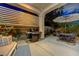Outdoor patio with grill, dining table, shade umbrella, and bench seating at 12 Kennesaw Rd, Henderson, NV 89052