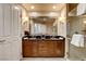 Bathroom featuring dual vanities with dark countertops and a large mirror at 145 E Harmon Ave # 3807, Las Vegas, NV 89109