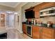 This kitchenette features wooden cabinetry, a mini-fridge, a microwave, and a sink for convenient in-room dining at 145 E Harmon Ave # 3807, Las Vegas, NV 89109
