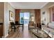 Bright living room features a seating area and a dining space with city views from large sliding glass doors at 145 E Harmon Ave # 3807, Las Vegas, NV 89109