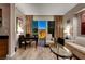 Enjoy city views from this cozy living room with a sofa, table, chairs and wood-style floors at 145 E Harmon Ave # 3807, Las Vegas, NV 89109