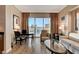 Bright living room features a seating area and a dining space with city views from large sliding glass doors at 145 E Harmon Ave # 3807, Las Vegas, NV 89109