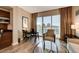 Bright living room features a seating area and a dining space with city views from large sliding glass doors at 145 E Harmon Ave # 3807, Las Vegas, NV 89109