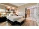 Comfortable main bedroom offering a king-size bed, bench, and access to the bathroom at 145 E Harmon Ave # 3807, Las Vegas, NV 89109