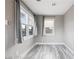 Bright bedroom featuring hard surface floors and two windows with bright gray curtains at 1718 Marlin Ave, Las Vegas, NV 89101