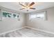 Cozy bedroom featuring wood-look flooring, neutral walls, two windows and a ceiling fan at 1718 Marlin Ave, Las Vegas, NV 89101