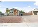 Charming single story home featuring a large gravel driveway and orange front door at 1718 Marlin Ave, Las Vegas, NV 89101