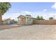 Charming single story home with a large parking area and a chain link fence at 1718 Marlin Ave, Las Vegas, NV 89101
