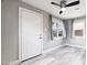 Bright living room featuring hard surface floors, two windows, and a modern ceiling fan at 1718 Marlin Ave, Las Vegas, NV 89101