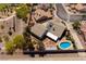 Overhead view of the home with a large pool, mature trees, patio and outdoor fireplace at 190 Channel Dr, Henderson, NV 89002