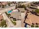 This aerial view showcases a home with a private backyard pool, lush landscaping, and a multi-car driveway at 190 Channel Dr, Henderson, NV 89002