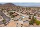 Aerial view of community featuring desert landscaping, tile roofs, pools, and mountain views at 190 Channel Dr, Henderson, NV 89002