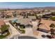 Aerial view of a home with a large pool, multiple car garage, and mature landscaping at 190 Channel Dr, Henderson, NV 89002